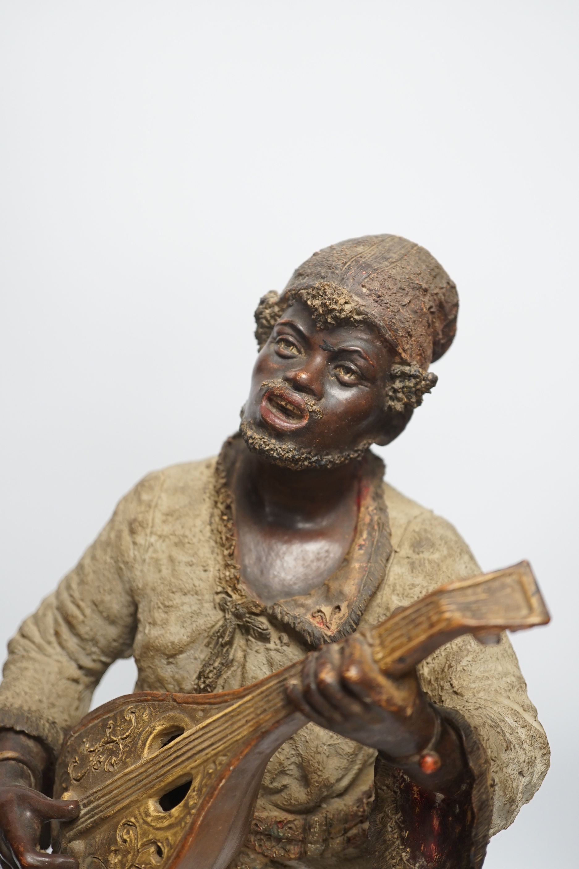 A pair of late 19th century Continental cold painted terracotta Nubian musician figures, 49cm